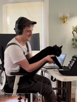 Jake at computer with cat