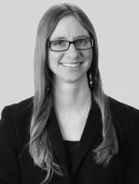 headshot of smiling woman wearing glasses