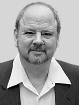 headshot of slightly smiling man with beard and moustache