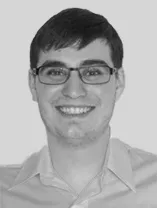 headshot of smiling man wearing glasses