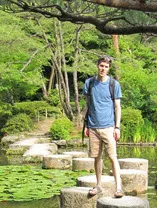 a color photo of Travis crossing a stream